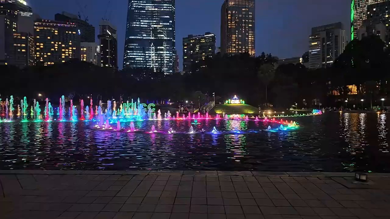 Lit-up fountain show on the lake at KLCC Park at night