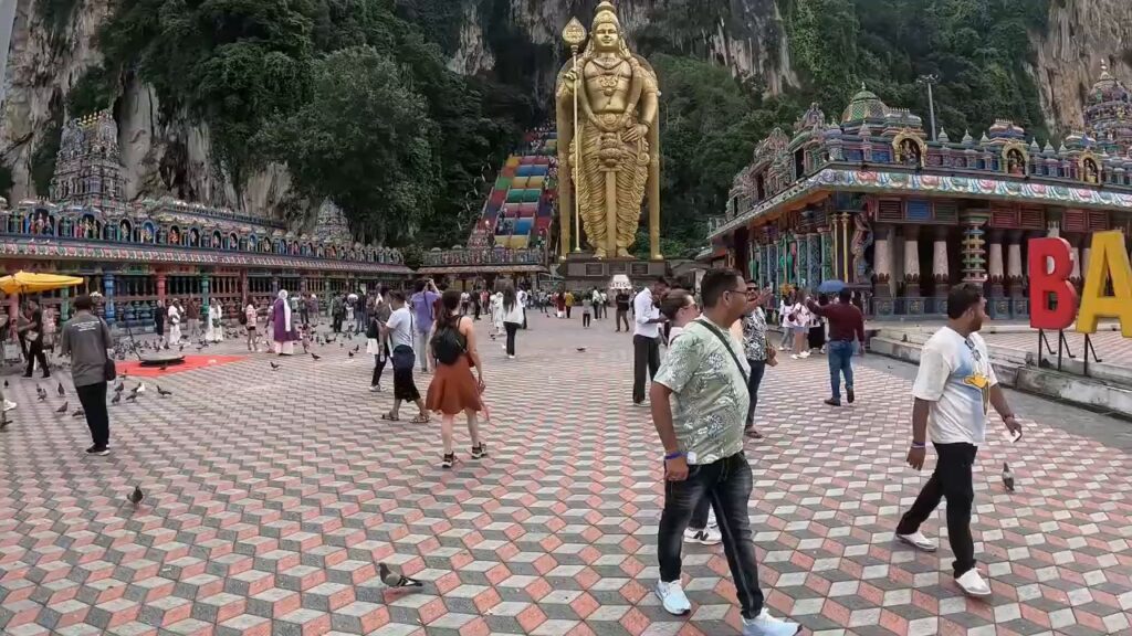 Golden Lord Murugan statue and plaza at the foot of Batu Caves