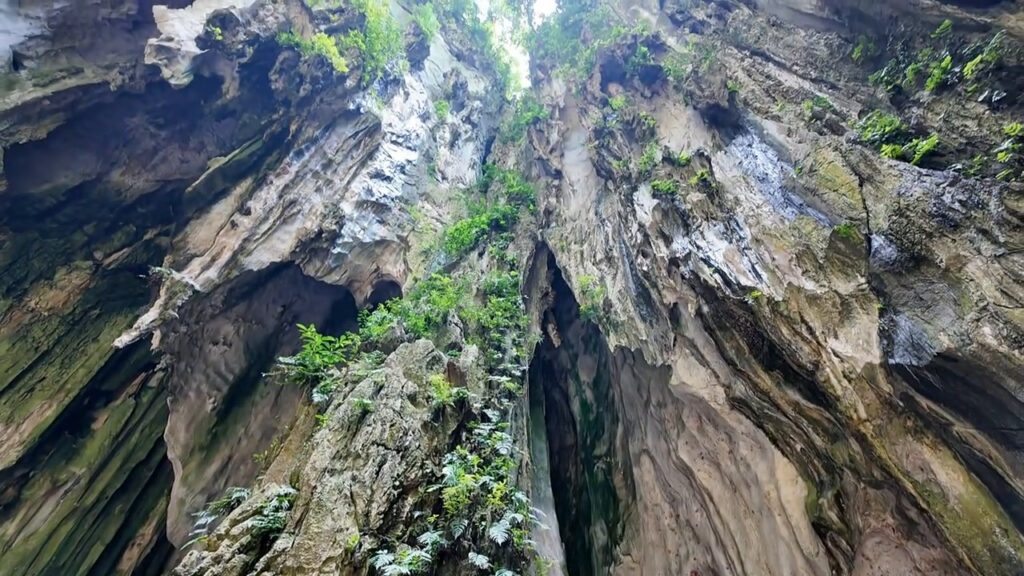 Towering limestone walls inside Batu Caves