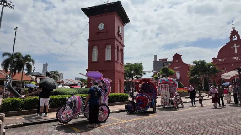 Dutch Square in Melaka with the red clock tower, Christ Church and decorated trishaws
