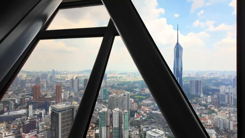 Merdeka 118 framed by the windows of the KL Tower Observation Deck