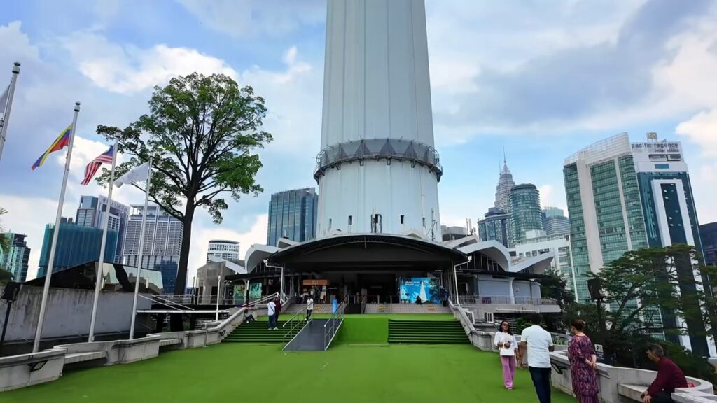 Base of KL Tower with souvenir shops and a garden