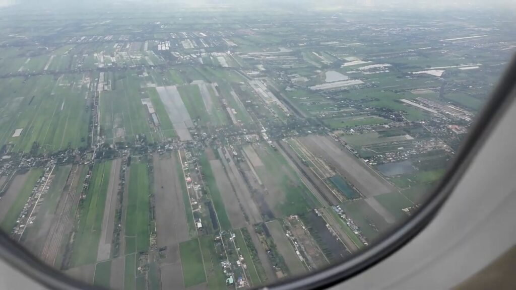 Farmland outside Bangkok seen from the plane window on approach