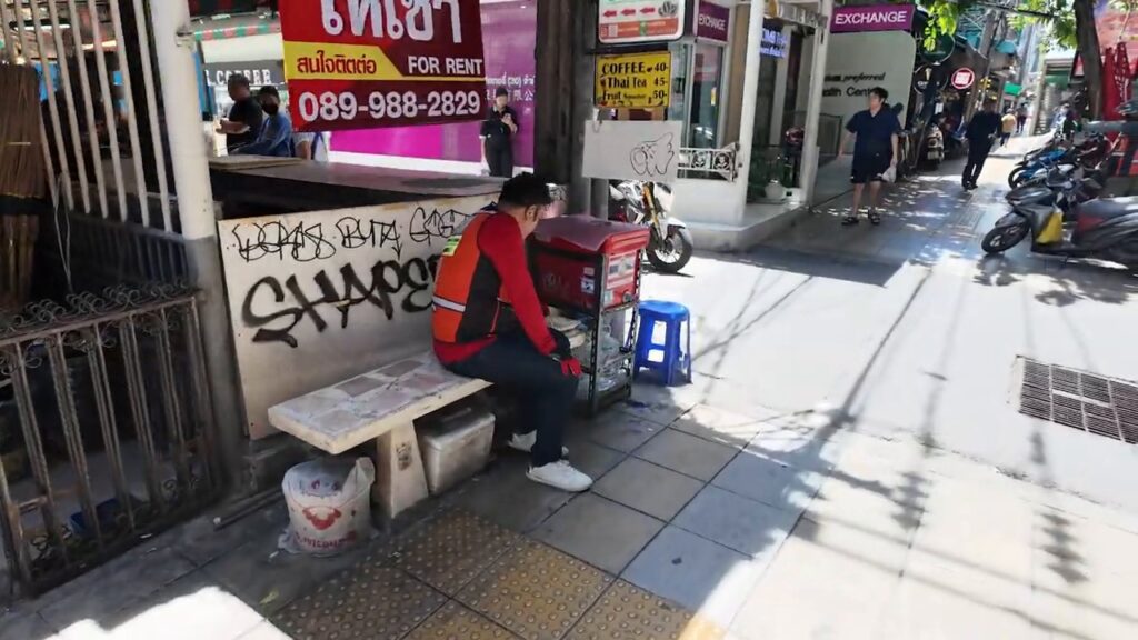 Local vendor at a sidewalk stall on Sukhumvit Road