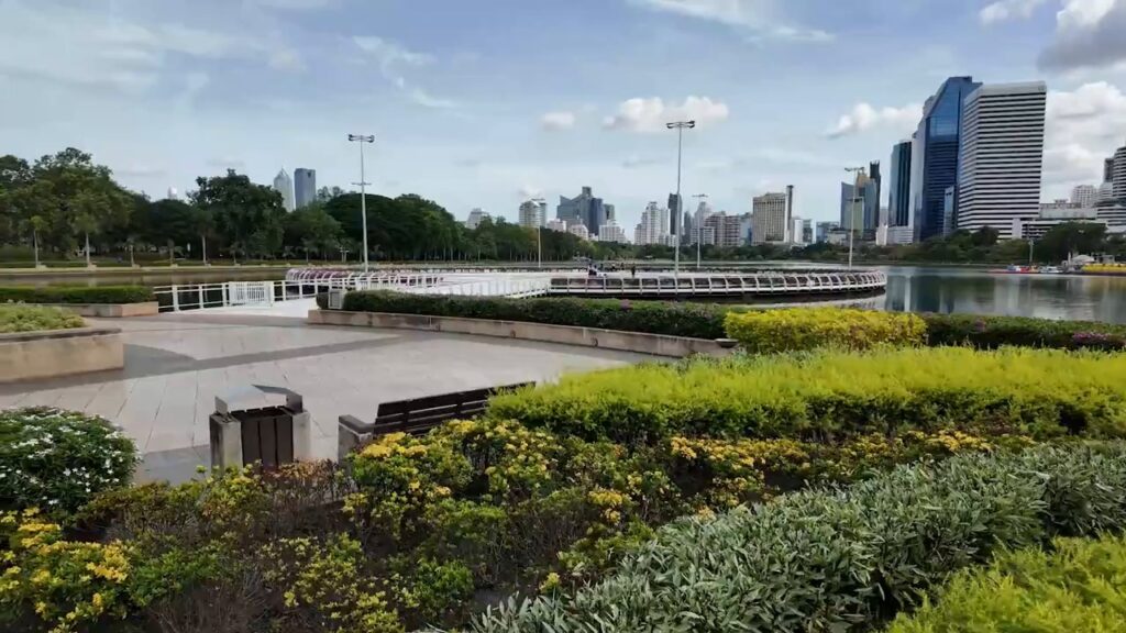 Lakeside plaza at Benjakitti Park with city towers