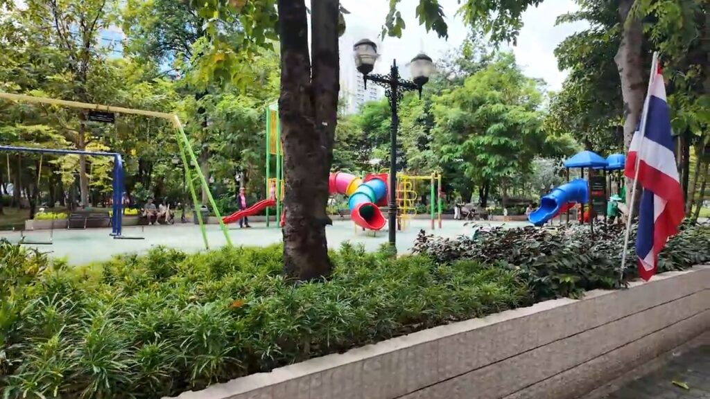 Colorful playground and Thai flag at Benchasiri Park