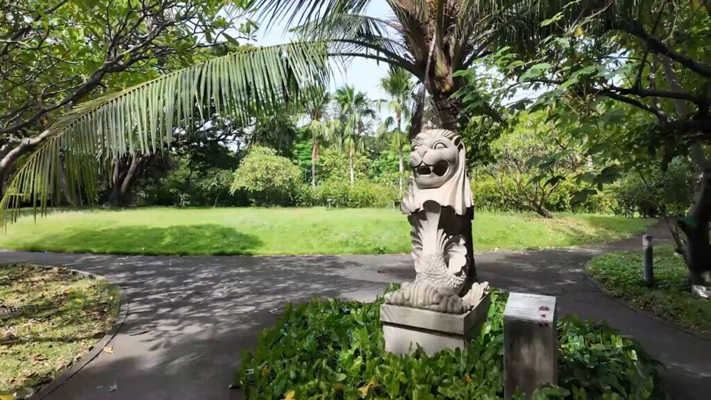 Stone lion statue beside a path at Benjakitti Park