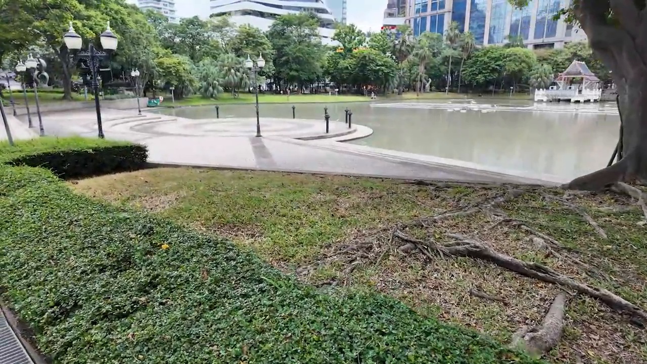 Pond and lawns at Benchasiri Park with Sukhumvit high-rises behind