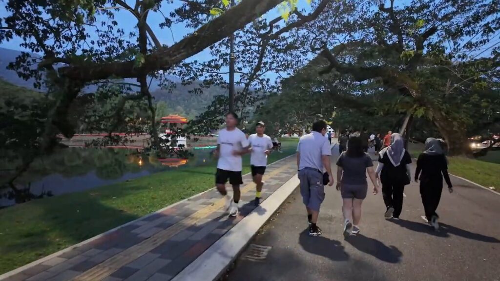 People walking along Taiping Lake Gardens at dusk