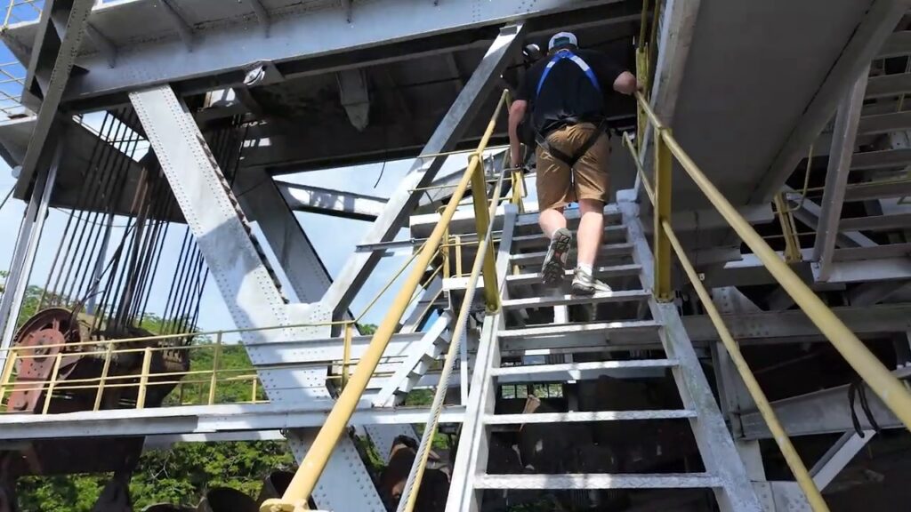 Climbing the steel stairs inside the tin dredge