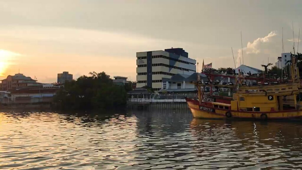 Sunset over fishing boats from the Kuantan River cruise