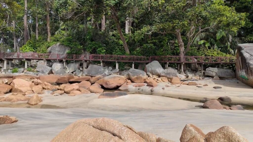 Boardwalk and rocks at the end of Teluk Cempedak beach