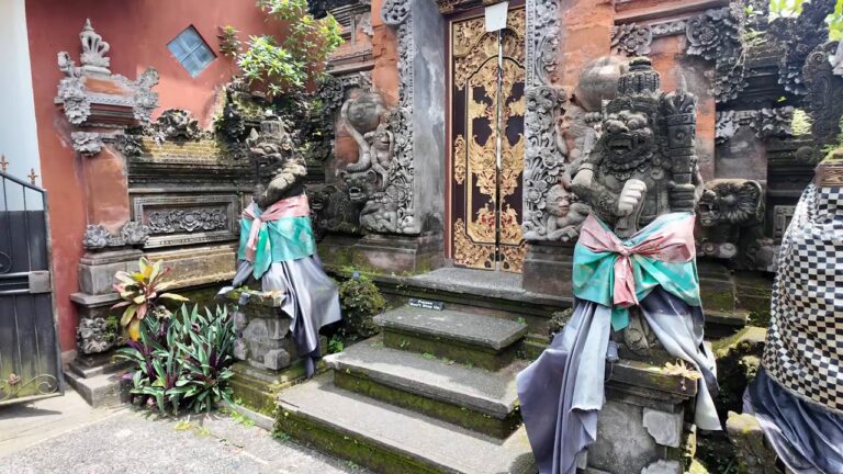 Carved stone gate and statues at Ubud Palace in Bali