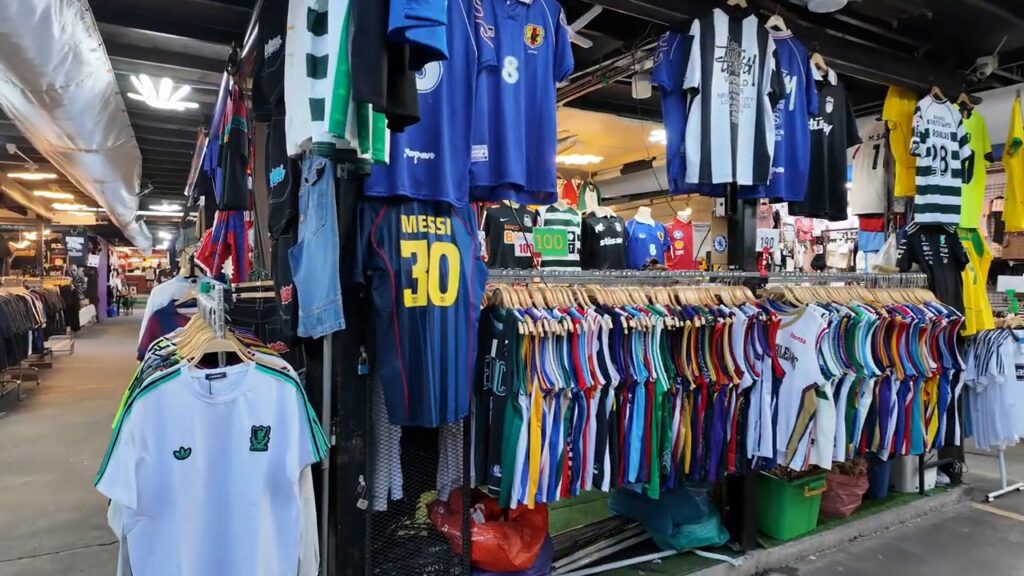 Racks of football shirts at the Train Night Market
