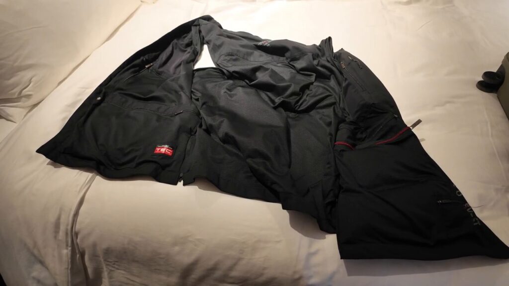SCOTTeVEST travel vest laid out on a hotel bed