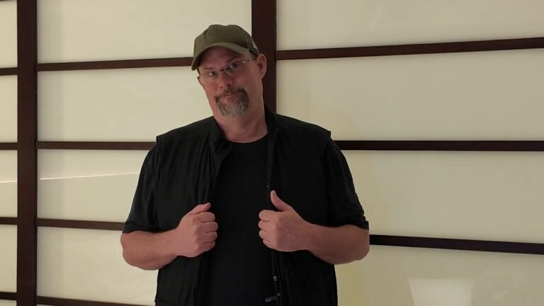Bill showing the pockets of his SCOTTeVEST travel vest