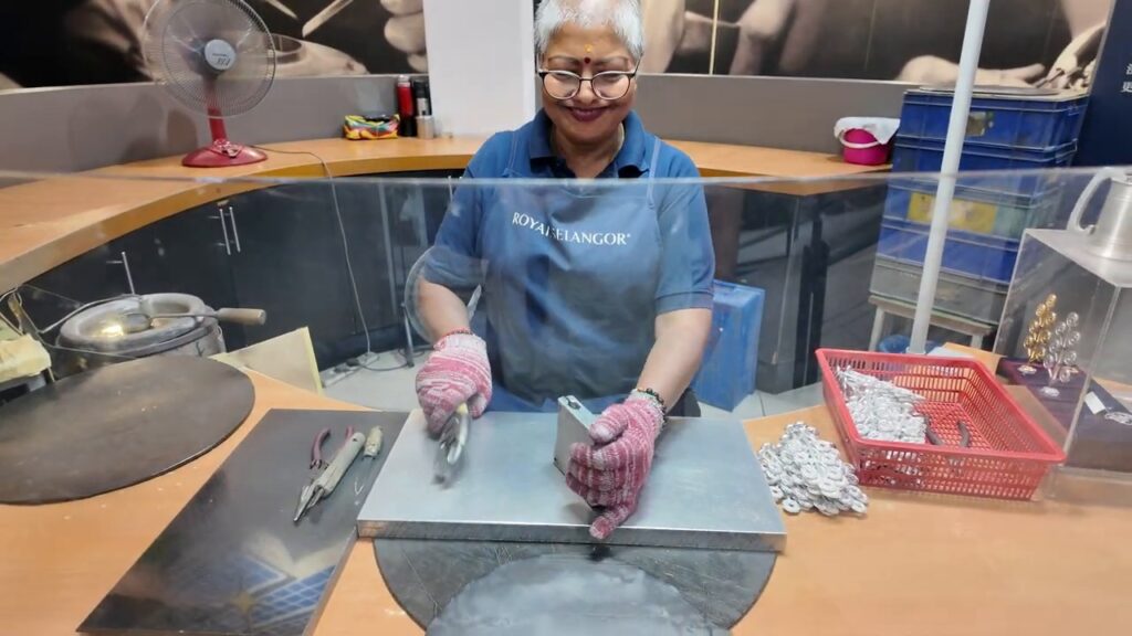 Royal Selangor worker casting pewter into a mold