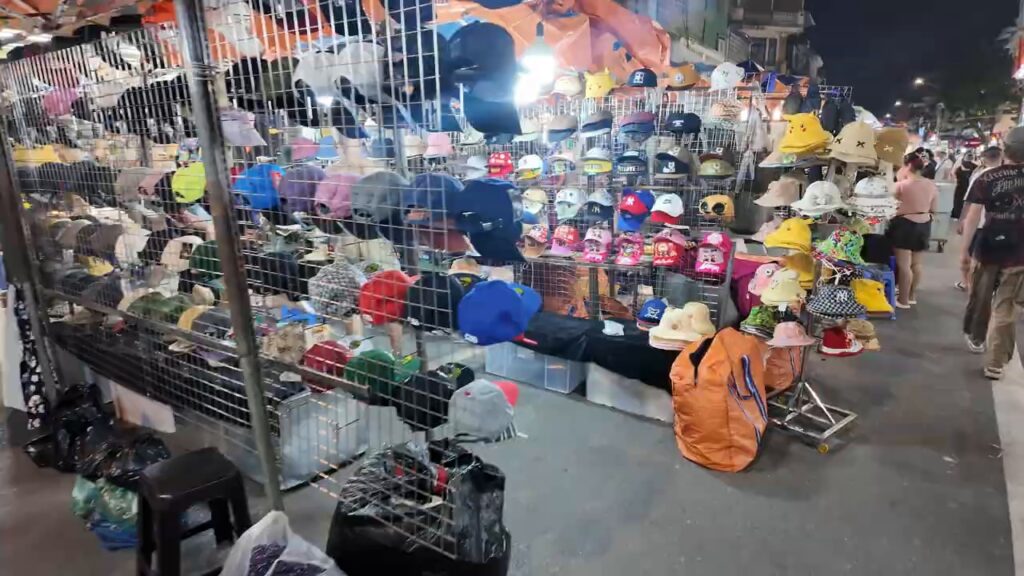Hats and caps stacked on a stall at the Hanoi night market