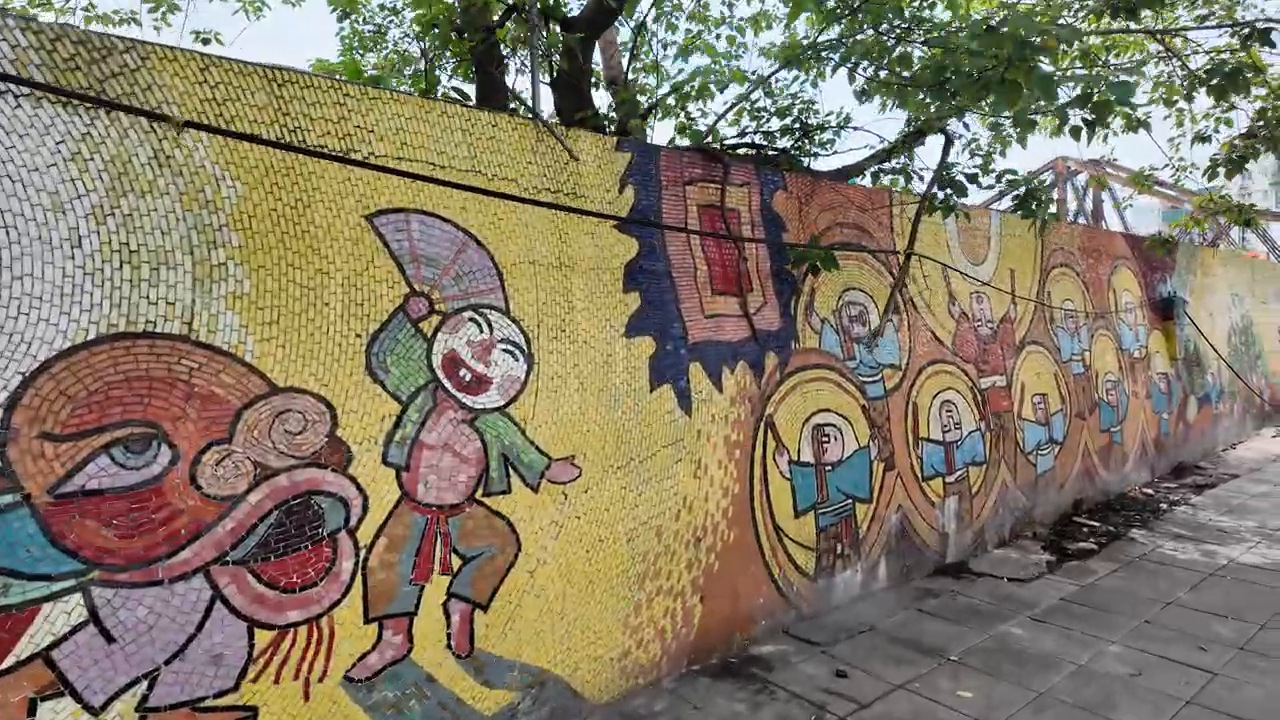Colorful ceramic mosaic of traditional figures on the Hanoi Ceramic Mosaic Mural