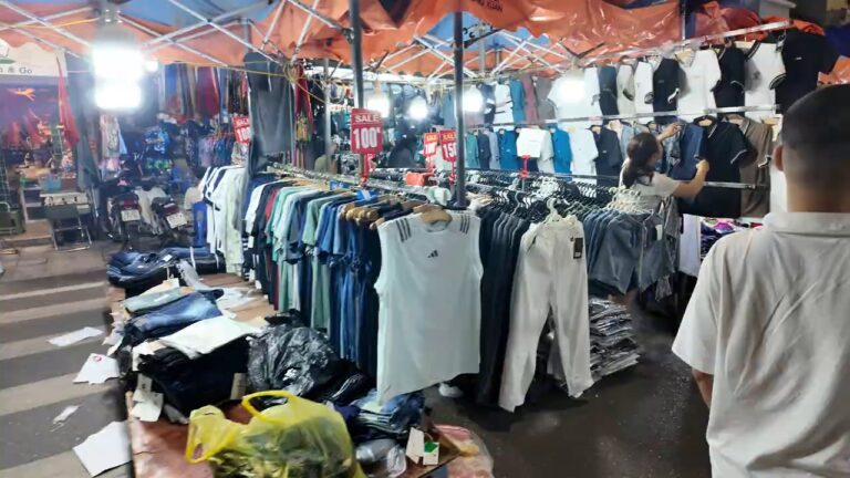 Clothing stalls lit up at the Hanoi weekend night market