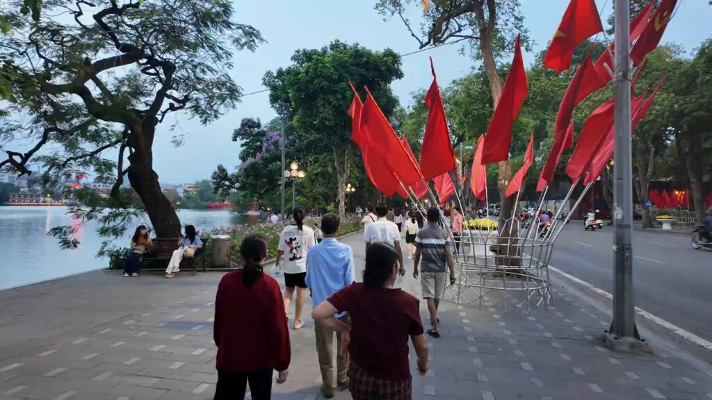 Red flags along the shore of Hoan Kiem Lake