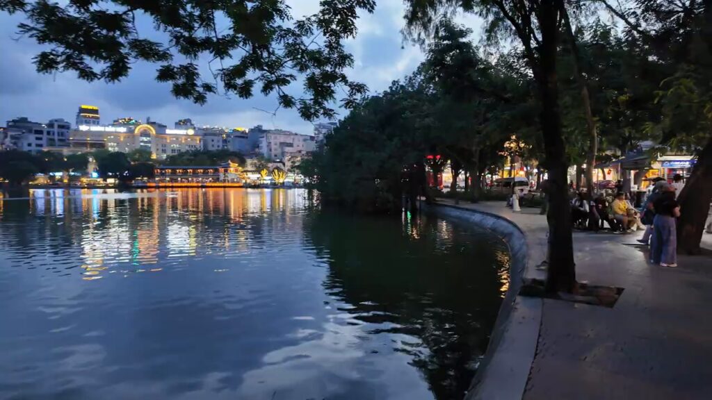 City lights reflected on Hoan Kiem Lake after dark
