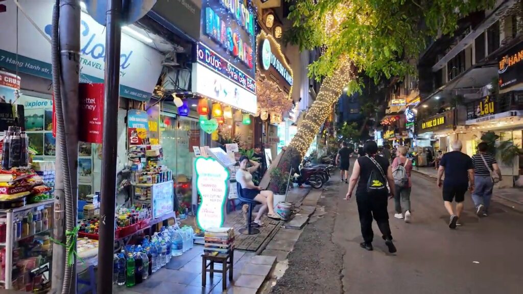 Busy shop-lined street at the edge of the Old Quarter near Hoan Kiem Lake