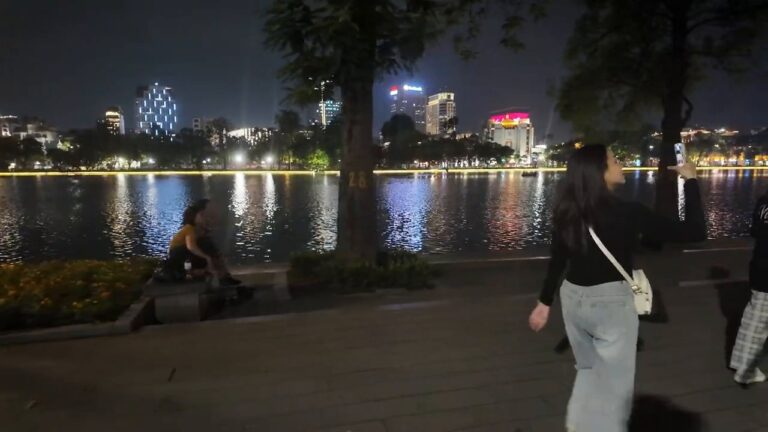 City lights reflected on Hoan Kiem Lake in Hanoi at night